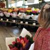 A young girls with a bouquet of flowers at Seattle's Pike Place Market with kids