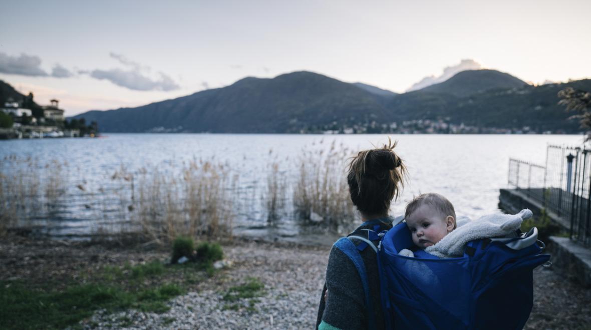 Mom carrying a baby in backpack by a lake is a wonderful thing to do with a baby in Seattle