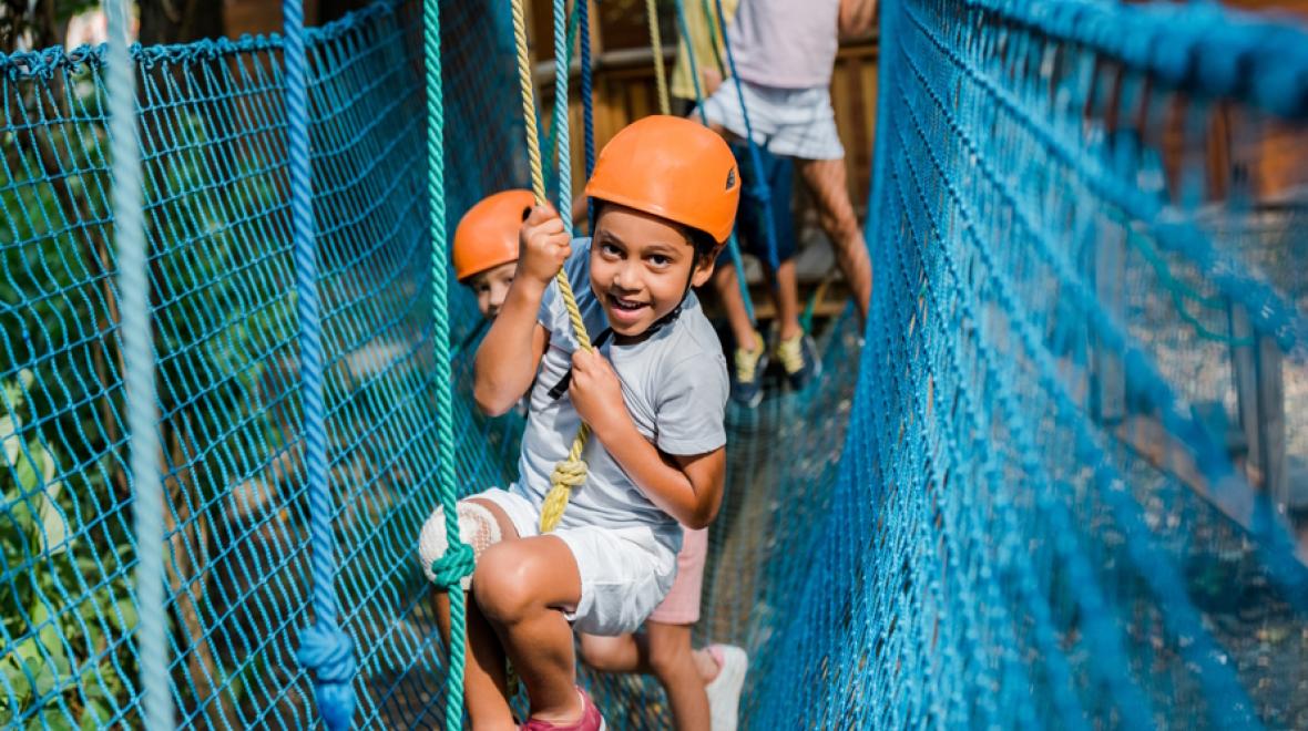 Kid on a high ropes course at a one-of-a-kind summer camp