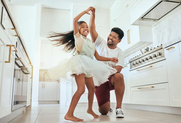 a child and dad dance for an indoor play activity