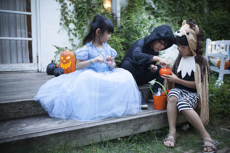 kids in costumes sorting candy