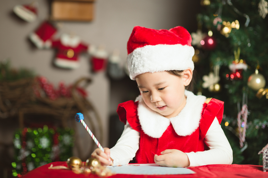 child writing a letter to Santa