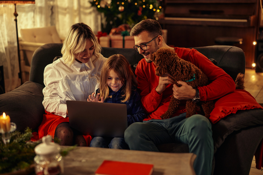 family looking at a laptop on Christmas morning