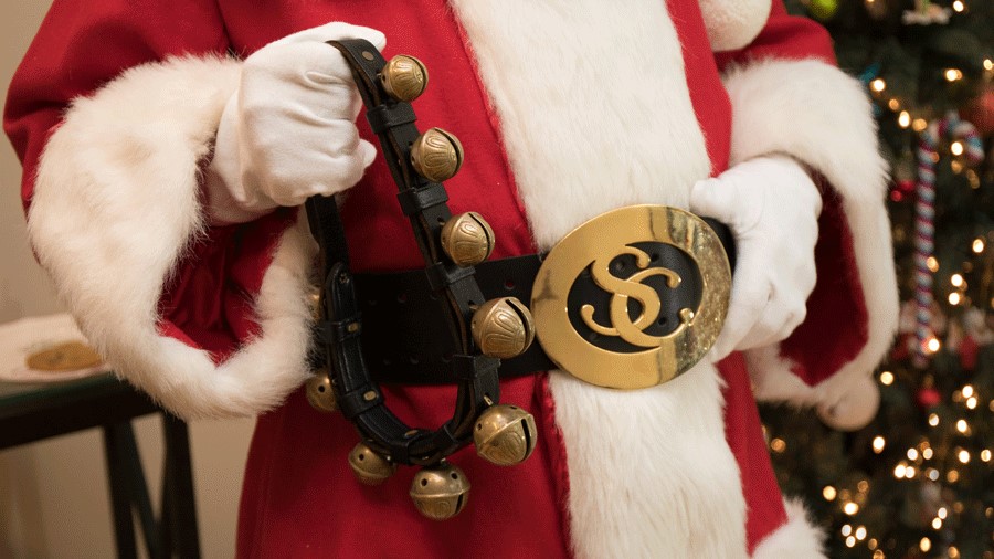 Santa' belt and jingle bells as he poses for pictures with kids in Seattle