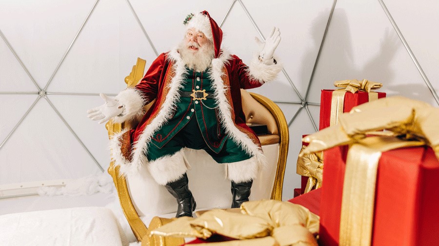 Santa sits in a globe at Kirkland Urban Frostival for pictures with kids