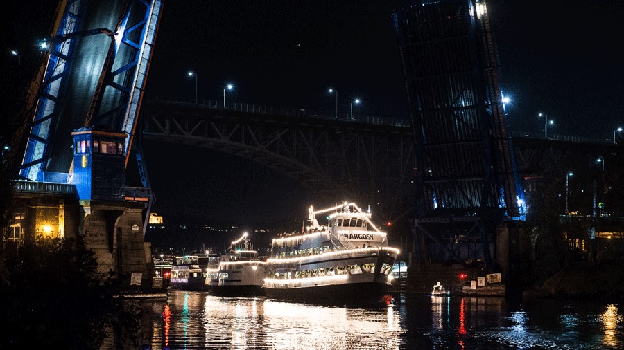 the Argosy Christmas Ship Parade of Boats leads decorated boats through the water