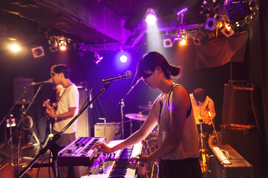 People playing instruments on a stage at a rock show