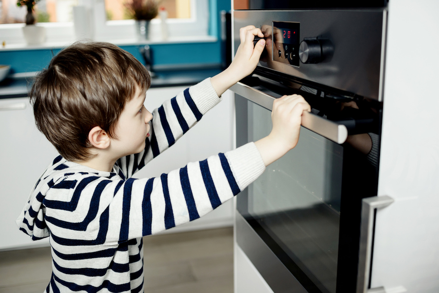 child setting an oven timer to limit screen time