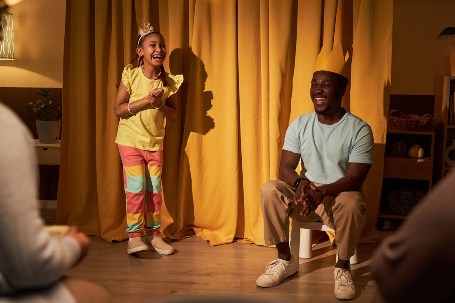 A girl and her father preforming a Thanksgiving day talent show