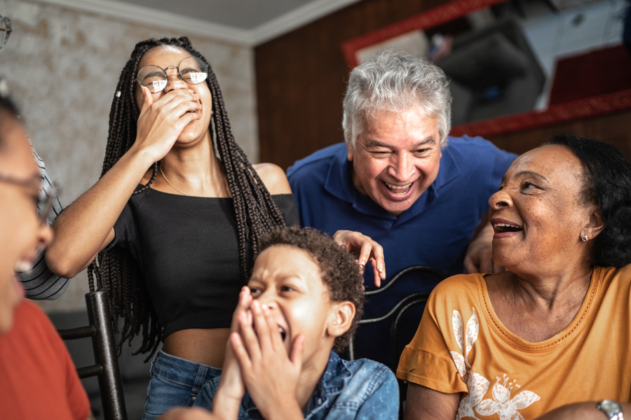 A family telling jokes and laughing on Thanksgiving