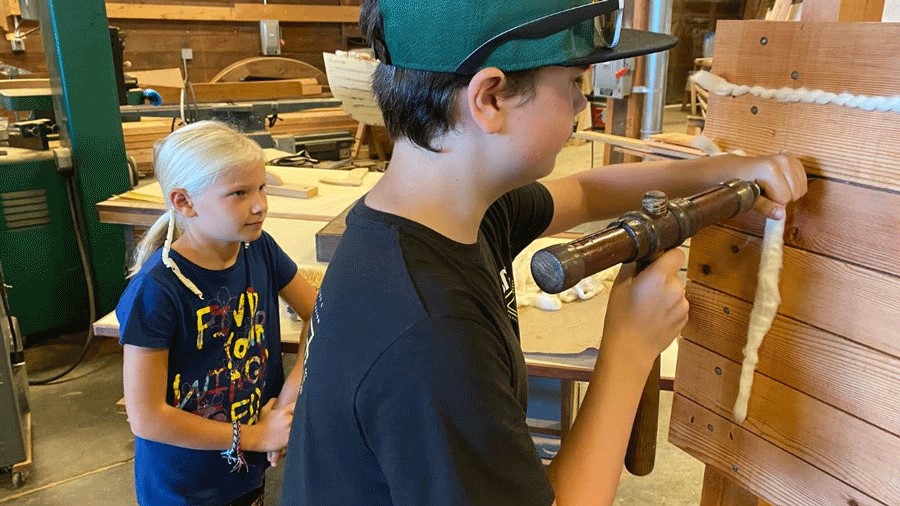 kids building boats at Gig Harbor BoatShop, a family-friendly indoor space with classes and activities