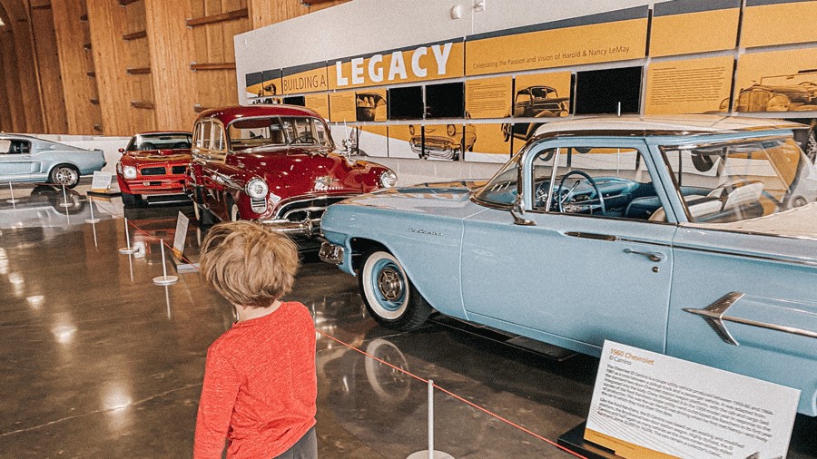 young boy walking through America's Car Museum in Tacoma, an indoor activity for families