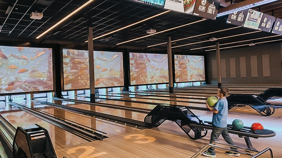 young kid bowling at Ocean5 bowling alley, a Tacoma-area indoor activity for families