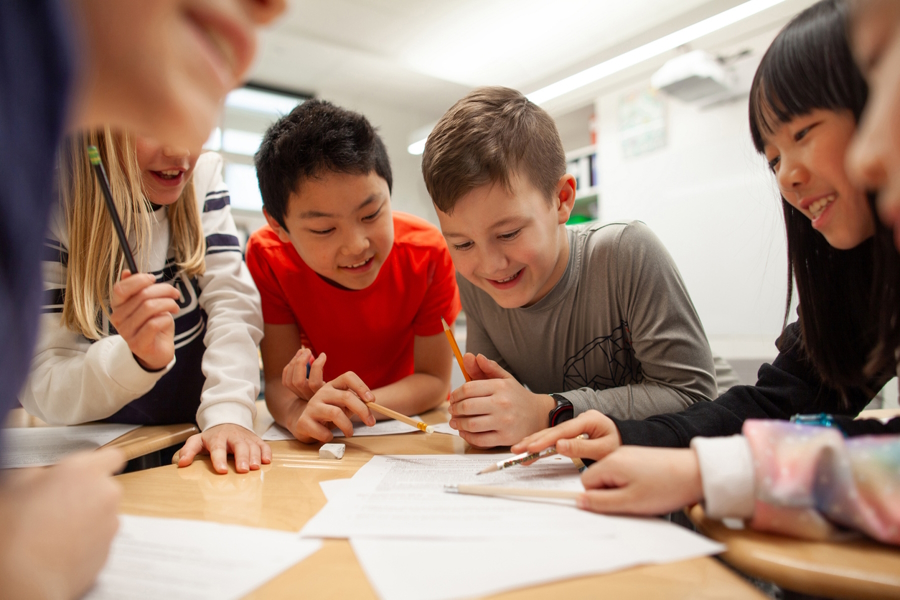 kids working together in a classroom without cell phones