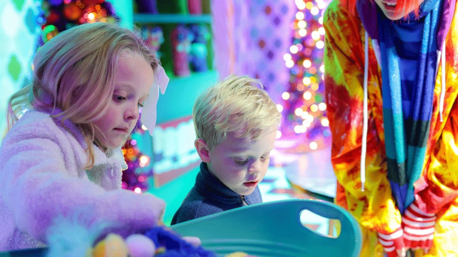 children choosing parts for their puppet in Santa's workshop at Kringle's Inventionasium in Seattle