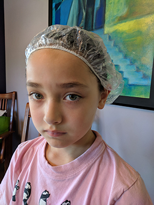 The author's daughter as she undergoes treatment for lice