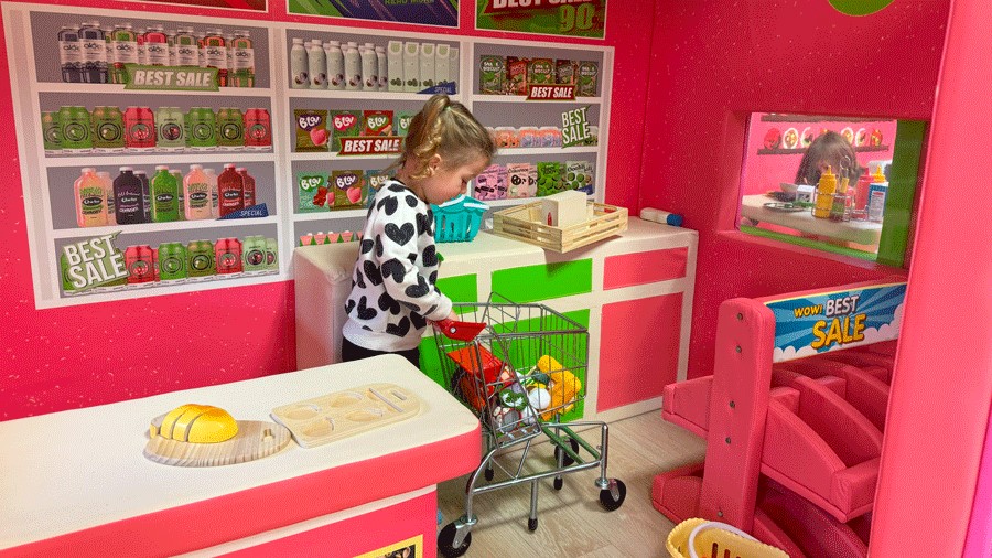 young girl pretend playing supermarket at Little Pandas Play Cafe in Everett, a new indoor play space for kids