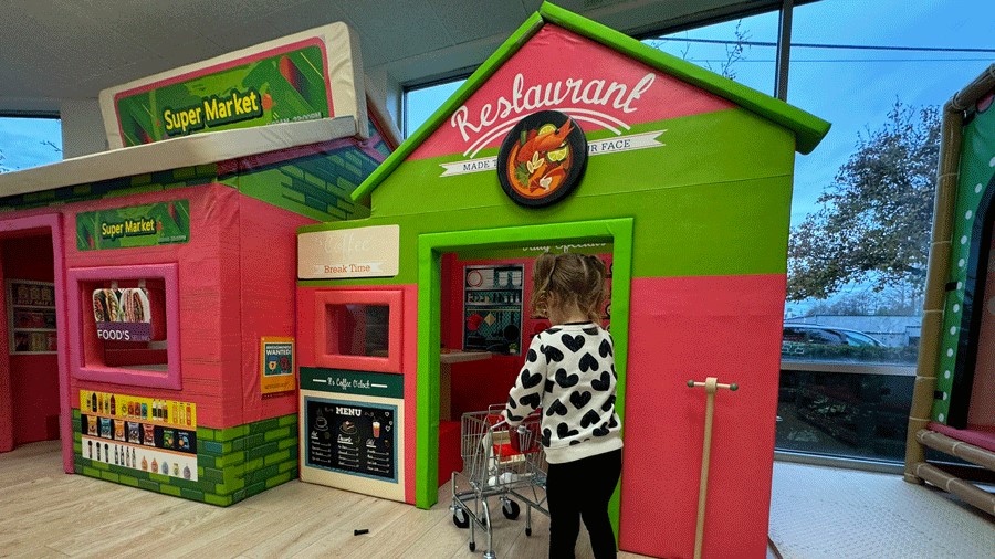 young girl pushing grocery cart to the restaurant at Little Panda Play Cafe