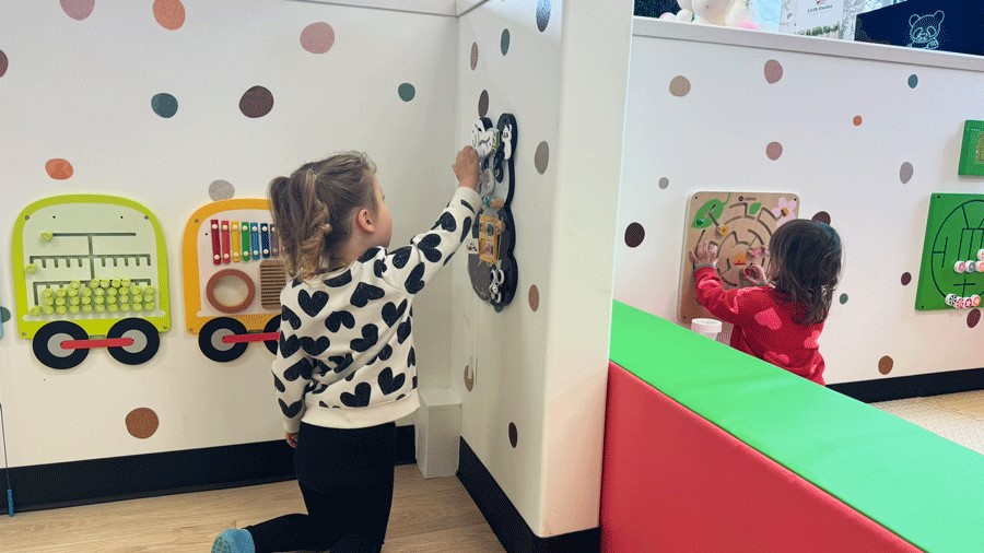 toddler and preschooler playing side-by-side at Little Pandas Play Cafe, an indoor playground in Everett