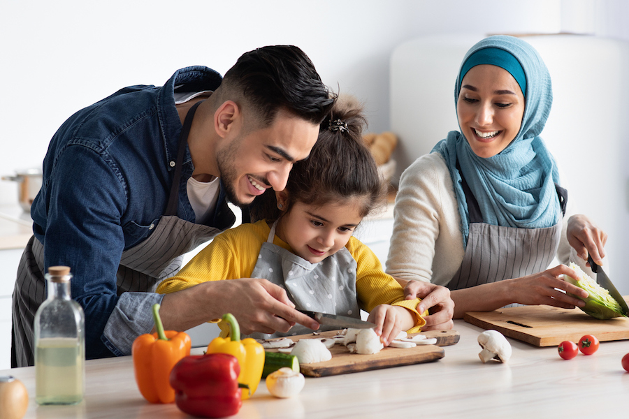 family having fun preparing dinner together