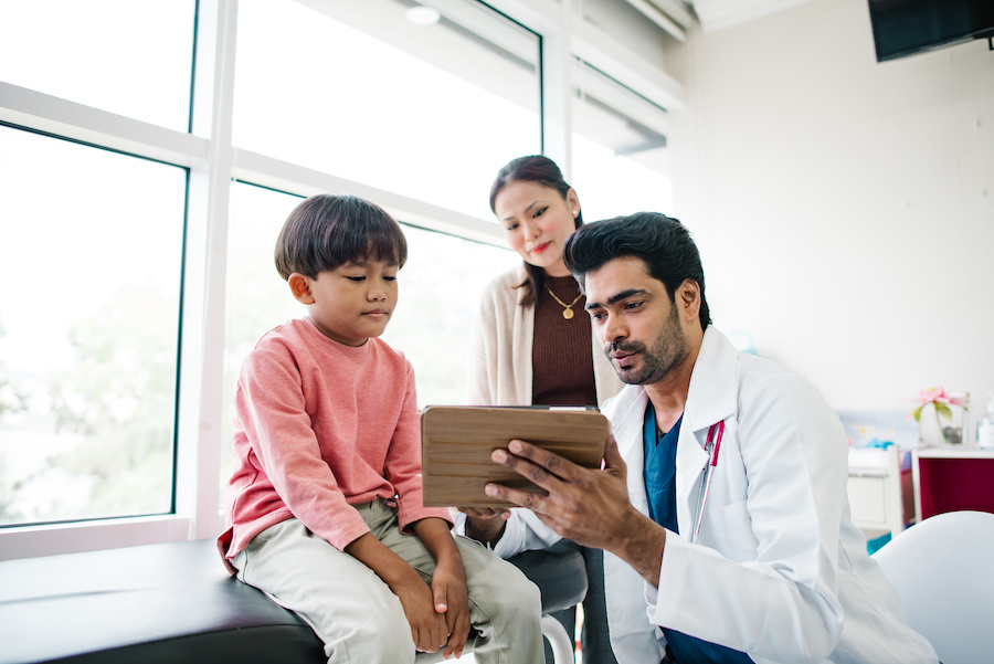 pediatrician discusses ADHD treatment options with a child and his parent