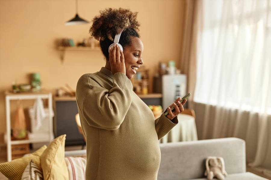 pregnant woman listening to a parenting podcast