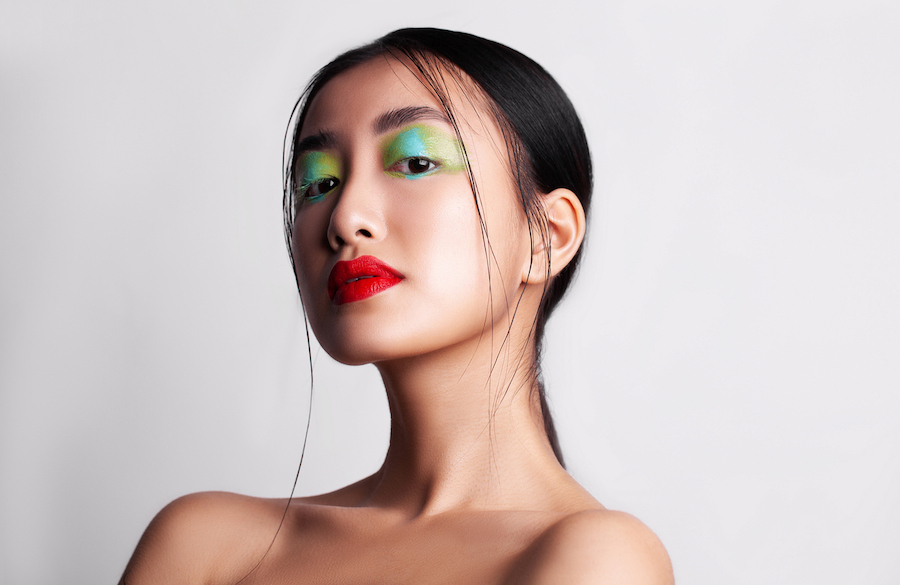 woman with red lipstick and colorful eye shadow