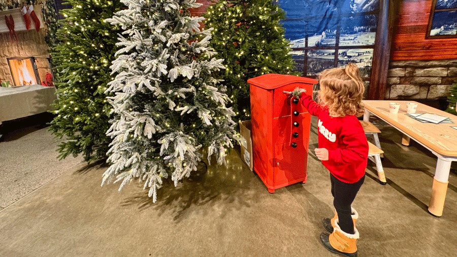 young girl mailing a letter to Santa at the Seattle Christmas Market, a kid-friendly holiday attraction