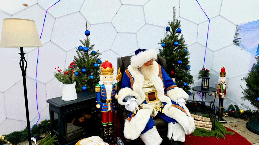 Santa photos at Seattle Christmas Market include Santa in a festive blue suit, sitting in a magical igloo