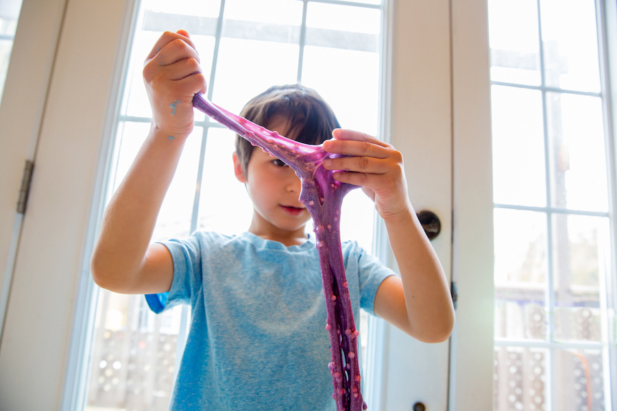 boy plays with diy slime