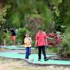 brothers playing mini golf at interbay in Seattle