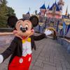 Mickey Mouse welcomes you to Disneyland in front of Sleeping Beauty's castle