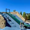 Young kids climb up the climbing mound at a new park in Duvall, one of the many things to do this weekend in Seattle