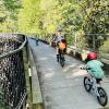 Families ride bikes over the Tokul Creek Trestle in Snoqualmie