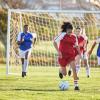 Young women playing soccer in the spring and are injury-free