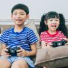 Boy and girl on the couch playing video games how to raise a healthy gamer