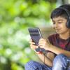 Young boy wearing headphones using an education app