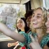 Teens riding the bus and having fun together on a outing for tween and teens