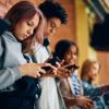 teen students using phones at school