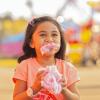 Girl eating cotton candy at the Washington sate Fair in Puyallup 