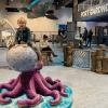 Toddler climbs on an octopus at Imagine Children's Museum in Everett