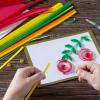 child crafting a pomegranate card for Rosh Hashanah 