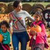 Mom and two daughters picking pumpkins at a pumpkin patch near Seattle