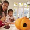 Mom and two kids having fun with Halloween crafts and activities