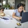 overwhelmed young mom trying to work from home while caring for a baby