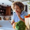 Woman sitting in front of a laptop ordering groceries online