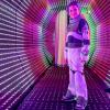 Young boy stands in the light tunnel at Cosmic Carnival in Seattle, a seasonal Halloween event for families