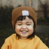 smiling toddler in fall hat and sweater