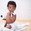 baby looking concerned while wrapped in toilet paper during the cost of living crises