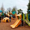 Family playing at Gene Coulon Memorial Park, a playground on the Eastside